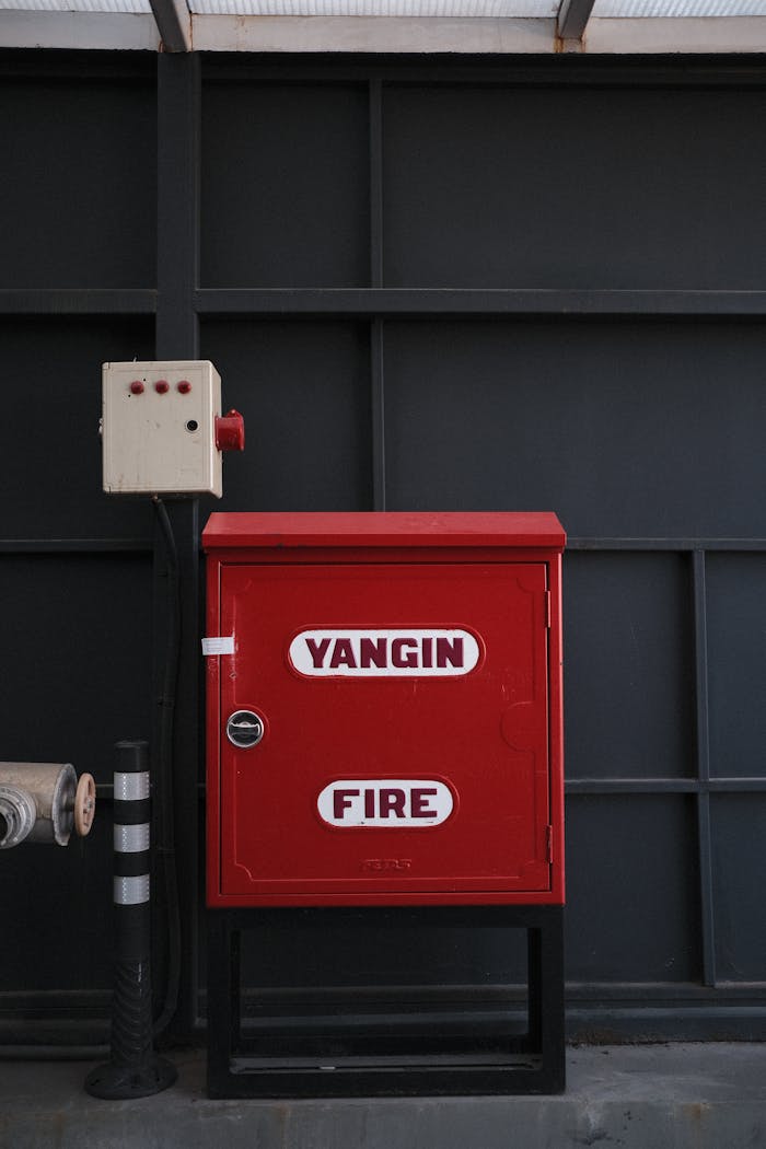 Indoor fire safety cabinet labeled 'Yangın Fire' for emergency use.